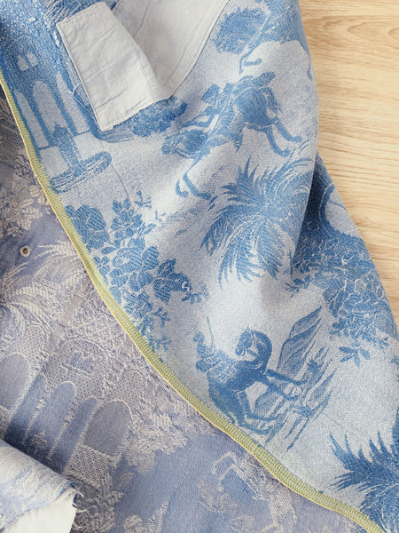 Blue faded ticking with dancer, buildings and soldiers on horseback. Spain c.1950 - 50×135 cm