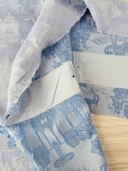 Blue faded ticking with dancer, buildings and soldiers on horseback. Spain c.1950 - 50×135 cm