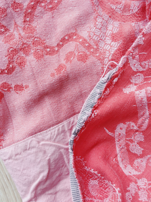 Reddish pink ticking with bouquets and ribbons. Spain c.1930 - 142×148 cm