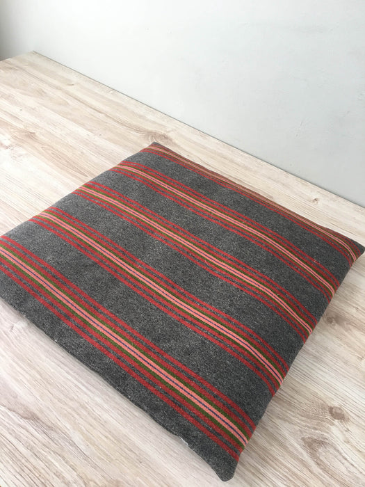 Cushion in pink, brown, and gray stripes. Wool. Sweden c.1900