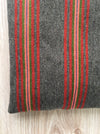 Cushion in pink, brown, and gray stripes. Wool. Sweden c.1900