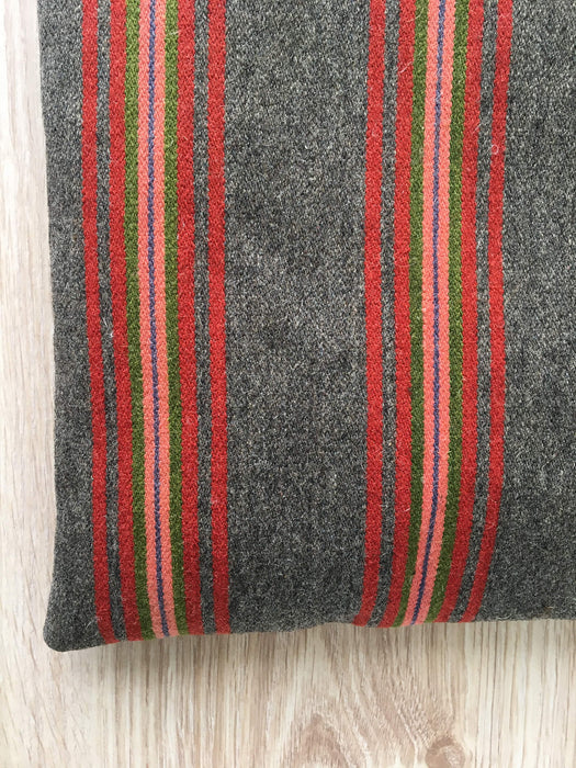 Cushion in pink, brown, and gray stripes. Wool. Sweden c.1900