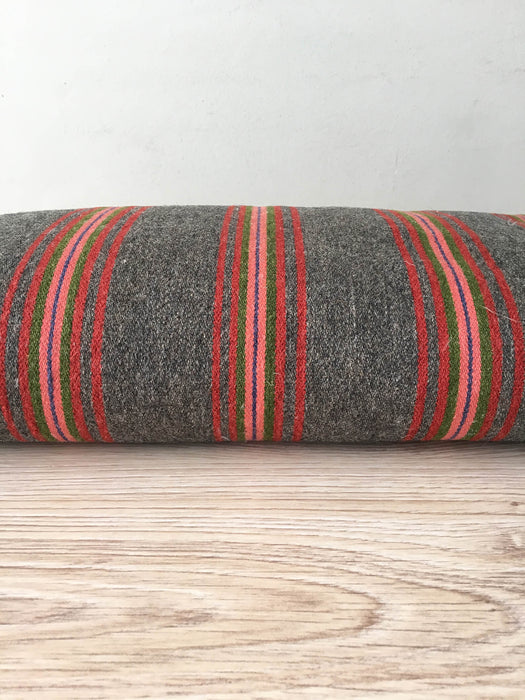 Cushion in pink, brown, and gray stripes. Wool. Sweden c.1900