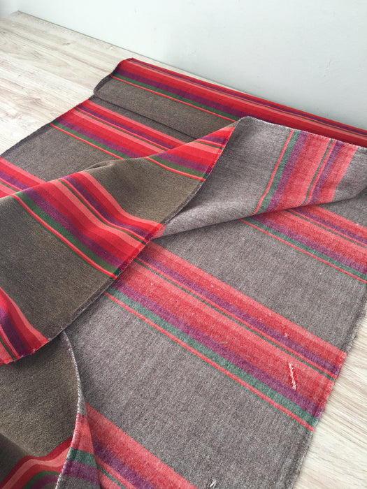 Long panels that were once a Swedish bolster in brown and vibrant warm colors (red, pink, orange, …). c.1900