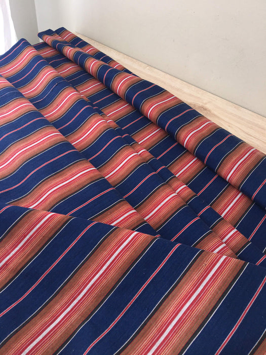 Swedish ticking in denim blue, orange, red, and thin white stripes. c.1940 - 94 cm × 3.3 meters