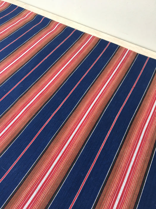Swedish ticking in denim blue, orange, red, and thin white stripes. c.1940 - 94 cm × 3.3 meters